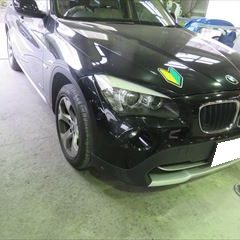 BMWのX1（ABA-VL18）：傷の修理方法と費用　フロントバンパー、バンパーロア、右アーチモール他の交換　部品代金116,800円/交換作業、塗装など　作業工賃84,000円/合計金額（税込）216,864円